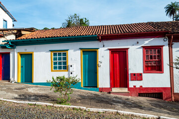 Sabará. Beautiful colorful old mansions in the historic city of Sabará. Brazil. Blue sky. Stone-paved street.