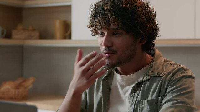 Shocked surprised amazed Indian male businessman astonish wonder excited guy Arabian man happy win with laptop winning online bet offer opportunity good achievement computer victory at home kitchen