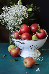 Vibrant colors still life with fresh red apples on a table. Healthy eating concept. Organic seasonal fruit close up photo. 