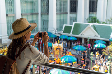 Asian woman travel in erawan shrine Bangkok city