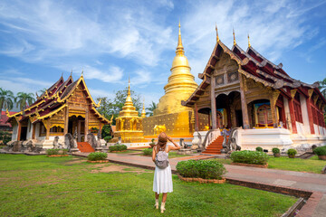 Asian traveller walking on street infront of wat phra singh temple