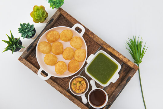 Desi Indian Street Food called Golgappe or Pani Puri.Famous Indian starter snack. Pani puri chaat, an Indian street food popular in Kolkata, Mumbai and North India. Indian street food.