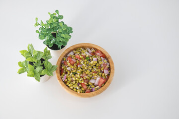 Sprouting green gram bean Indian salad with Onion, coriander leaf , green chili and tomatoes. Indian sprouting gram bean salad with isolated background.