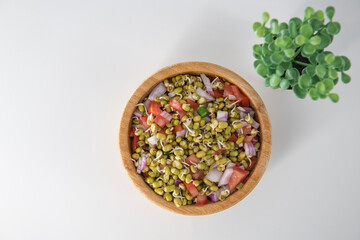 Sprouting green gram bean Indian salad with Onion, coriander leaf , green chili and tomatoes. Indian sprouting gram bean salad with isolated background.