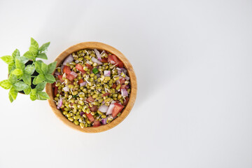Sprouting green gram bean Indian salad with Onion, coriander leaf , green chili and tomatoes. Indian sprouting gram bean salad with isolated background.