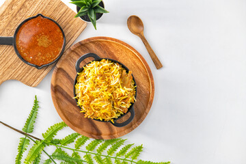Dum Handi Mutton Biryani or gosht pilaf is prepared in an earthen or clay pot called Handi.  Popular Indian non vegetarian food. Special handi biryani in an isolated background. 