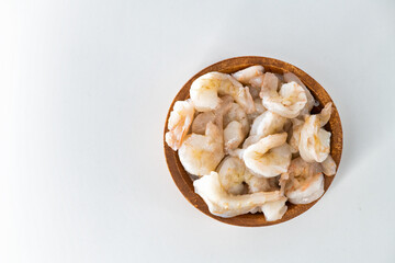 Fresh Raw shrimps cleaned and kept it in a wooden bowl. Raw shrimps in wooden bowl and isolated in white background...