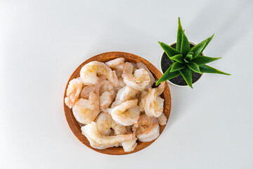 Fresh Raw shrimps cleaned and kept it in a wooden bowl. Raw shrimps in wooden bowl and isolated in white background...