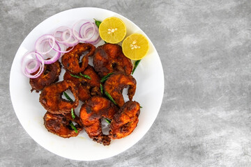 Deep South Indian spicy fish fry on a plate with isolated background. Fresh spicy fish fry South...