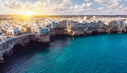 Fototapeta na wymiar Aerial view of Polignano a Mare, a village built on the edge of the sandstone cliffs above the Adriatic Sea in Apulia, Italy.