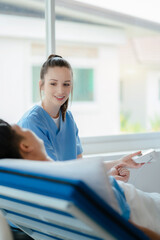 Fototapeta premium Female doctor having blood pressure test male at the clinic in the morning.