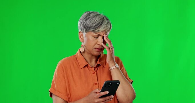 Senior woman, phone scam and green screen with a frustrated female with spam. Isolated, studio background and mobile glitch with an elderly person feeling confused from internet email problem