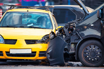 Crash Scene: Blue and Yellow Cars Collide on the Road