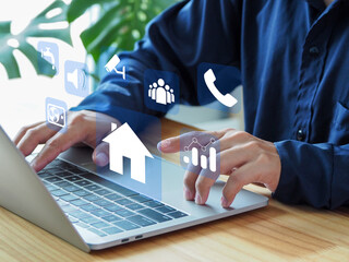Real estate agent working on home laptop computer modern technology automation of house management...