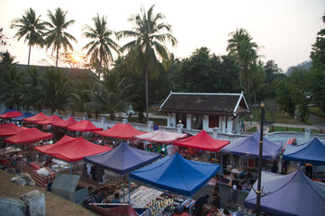 Top view of Night market in Evening time is popular tourist attraction sell a lot of souvenirs and handicrafts. and located on the main road in the Luang Prabang city, Laos.