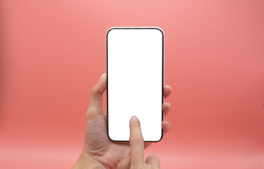 woman holding blank screen mobile on pink background.