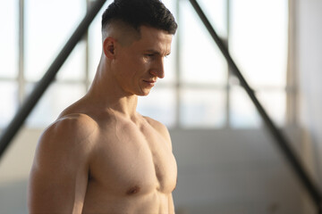 Fototapeta na wymiar Serious hispanic muscular man, athlete, indoors. Healthy lifestyle concept, copy space