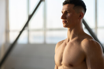 Obraz na płótnie Canvas Attractive muscular latin man, athlete, indoors. Healthy lifestyle concept, copy space