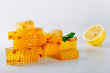 Multi-colored fruit marmalade lies on a white table. Recipe for homemade healthy marmalade.