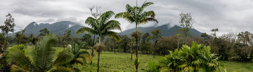 Fototapeta na wymiar A panorama view of the cloud covered Arenal volcano on the outskirts of La Fortuna, Costa Rica in the dry season