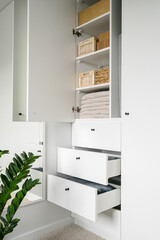 storage boxes with laundry in modern wardrobe