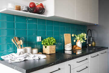 induction hob, kitchenware and utensils at kitchen with modern interior