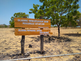 Warning sign for not littering and not operating drones in the bekol savanna, baluran national park, banyuwangi, East Java, Indonesia