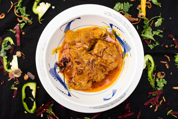 Chicken jhal fry served in dish isolated on dark background top view of indian spices food