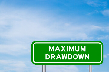 Green color transportation sign with word maximum drawdown on blue sky with white cloud background