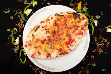 Kashmiri Naan served in dish isolated on dark background top view of indian spices food