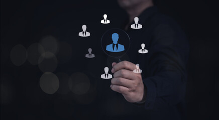 HRM or Human Resource Management concept : businessman using Magnifier glass and  focus to manager icon for  recruitment leadership and customer target group to enter the position in company.