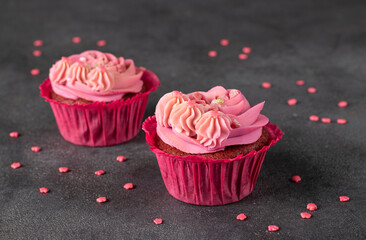 Cupcakes Red velvet decorated with pink cream on dark gray background