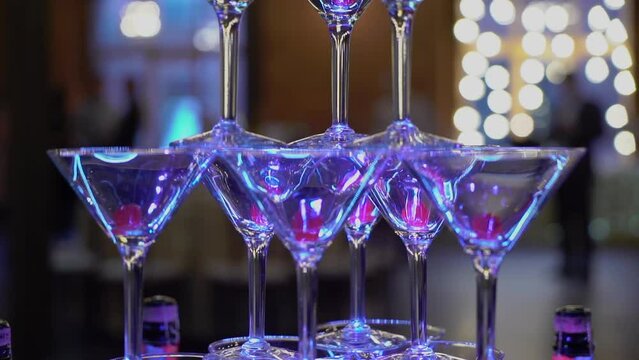Tower of glasses at celebration party. Welcome drinks, tower of champagne or sparkling wine. Empty with red berry. Restaurant ready for reception. Alcoholic beverage.