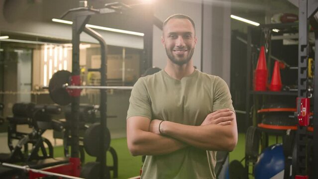 Portrait African American multiethnic fitness trainer guy sportsman male strong muscular athlete bodybuilder man with arm crossed smile confident at camera posing smiling in sport club gym workout
