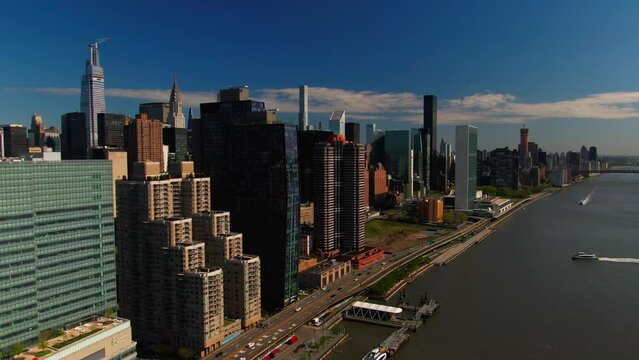 Iconic NYC Midtown Manhattan buildings East River waterfront FDR Drive traffic cityscape skyline mid day