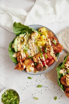 Vertical closeup shot of delicious vegan food bowls with vegetables on the white table