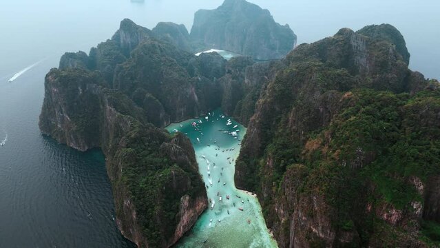 Cinematic top view the whole island of Ko Phi Phi Lee with iconic Maya Bay and Pileh Lagoon surrounded by limestone cliffs on Phi Phi islands in Thailand. Paradise tropical island on the sea