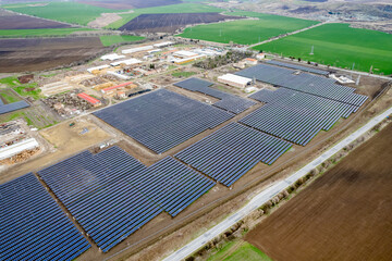 Aerial drone shot. Solar panels farm in a field.
