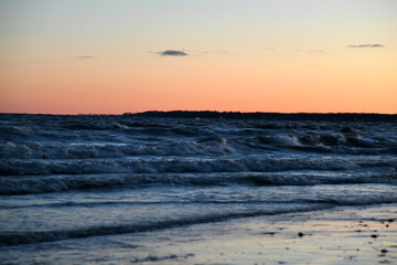 Lake Erie sunrise with crashing waves. Blue orange sky. Western New York.