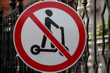 A road sign prohibiting an use of kick scooters, is seen at pedestrian street in a city