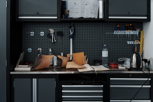 Assembled prosthetic leg and foot on table in orthopedic equipment workshop, disability concept