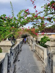 Stone bridge surrounded by flowers
