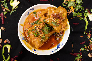 Nehari or nihari served in dish isolated on dark background top view of indian spices food