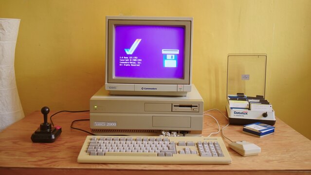 BERLIN - FEBRUARY 23, 2022: Vintage Commodore Amiga Boot Screen on classic Monitor 1084S. Amiga 2000 was a popular Gaming PC in the 80s and 90s. Start-up Screen showing symbol of a Floppy Disk