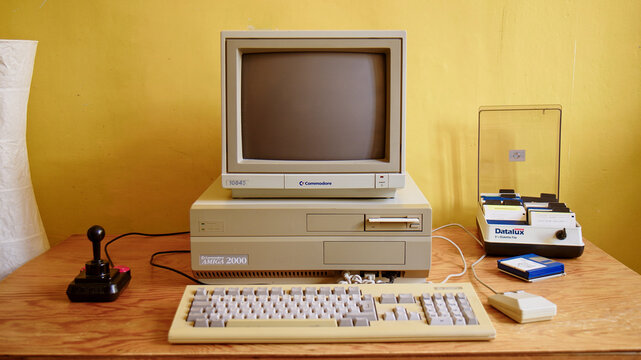 BERLIN - FEBRUARY 23, 2022: Vintage Commodore Amiga 2000 PC with Monitor 1084S, Competition Pro Joystick and Mouse. It was a popular Gaming PC in the 80s and 90s.