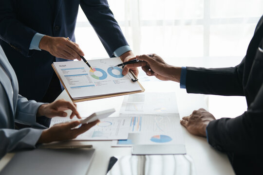 Close up view of business people working with new project, presentating and analyzing the marketing and investment plan.