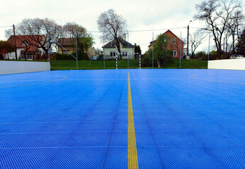 outdoor small soccer court with blue vinyl sport floor. interlocking tiles. modern recreational and...