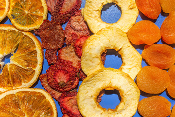 Top view of dried fruits. Dried apple, orange, strawberry and apricot slices. Preserved foods.