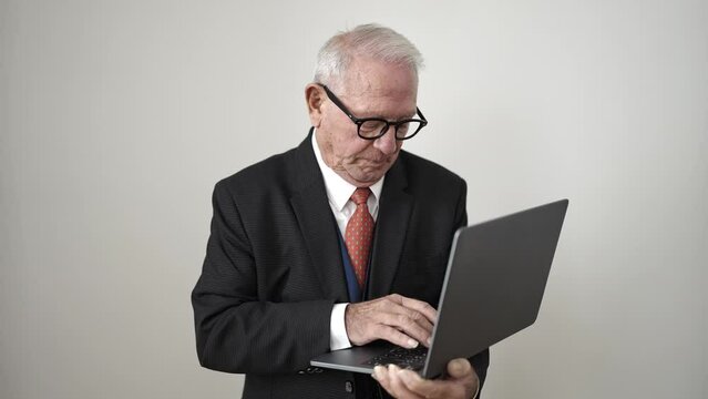 senior standing pointing to laptop over isolated white background