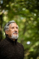 Elderly caucasian male walking outdoors on an autumn, fall day